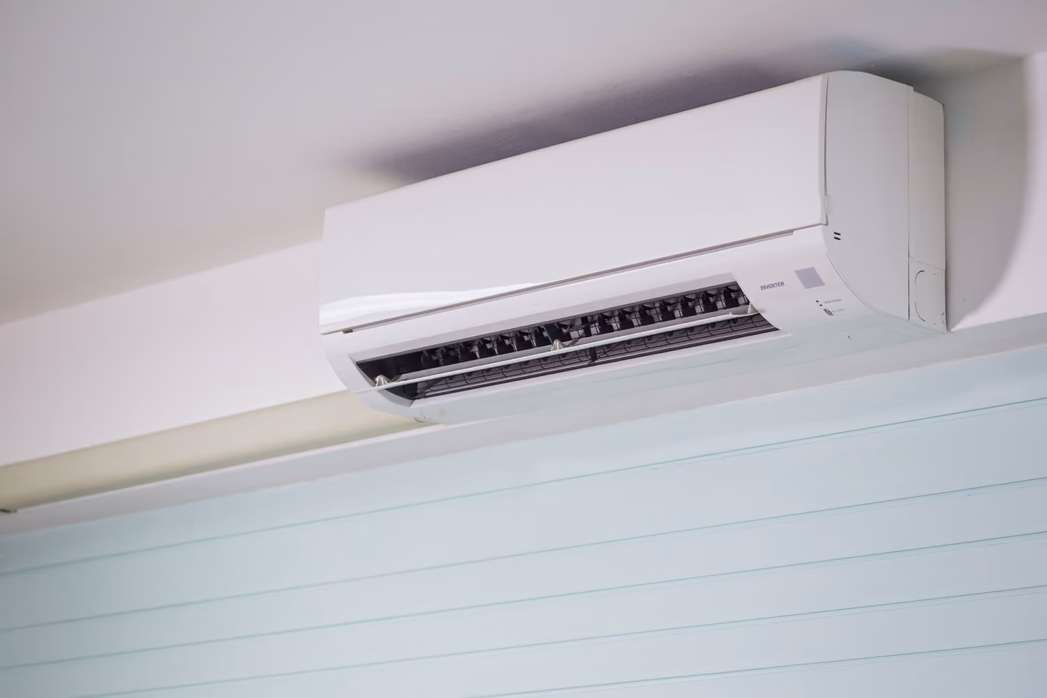 Wall-mounted air-conditioning unit installed neatly in a light interior
